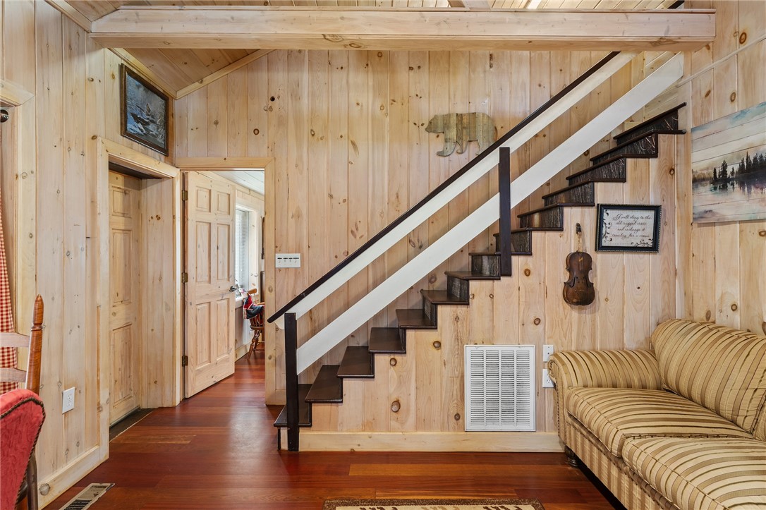 260 Hickory Ridge Mountain Rest, SC 29664 - Photo 12 of 39 This interior features rich wood flooring and paneled walls, creating a rustic and inviting atmosphere.