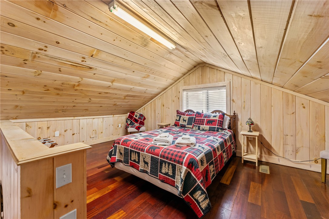 260 Hickory Ridge Mountain Rest, SC 29664 - Photo 19 of 39 This cozy bedroom features warm wood paneling and rich hardwood floors.