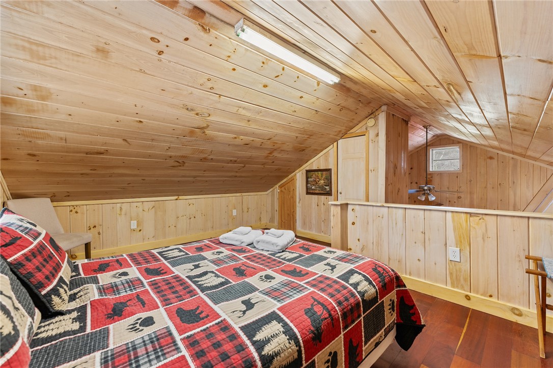 260 Hickory Ridge Mountain Rest, SC 29664 - Photo 20 of 39 An inviting sleeping loft features warm wood finishes and durable flooring, creating a cozy and functional space.