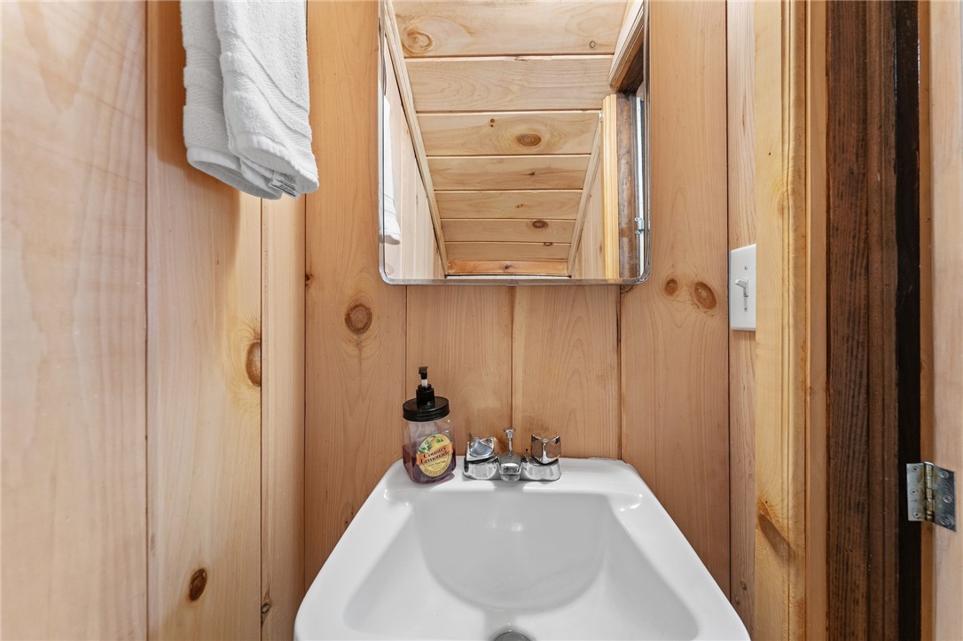 260 Hickory Ridge Mountain Rest, SC 29664 - Photo 22 of 39 This bathroom features natural wood walls, offering a rustic yet clean aesthetic.