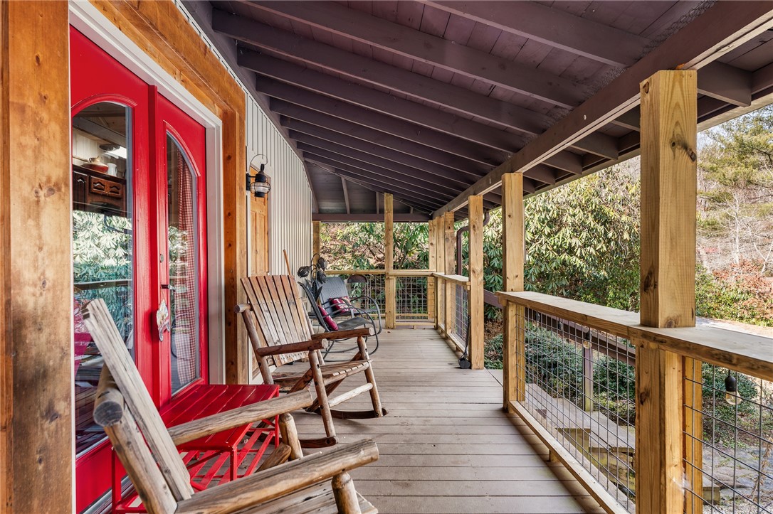 260 Hickory Ridge Mountain Rest, SC 29664 - Photo 4 of 39 Embrace outdoor living on this expansive covered porch, perfect for enjoying nature's tranquility.