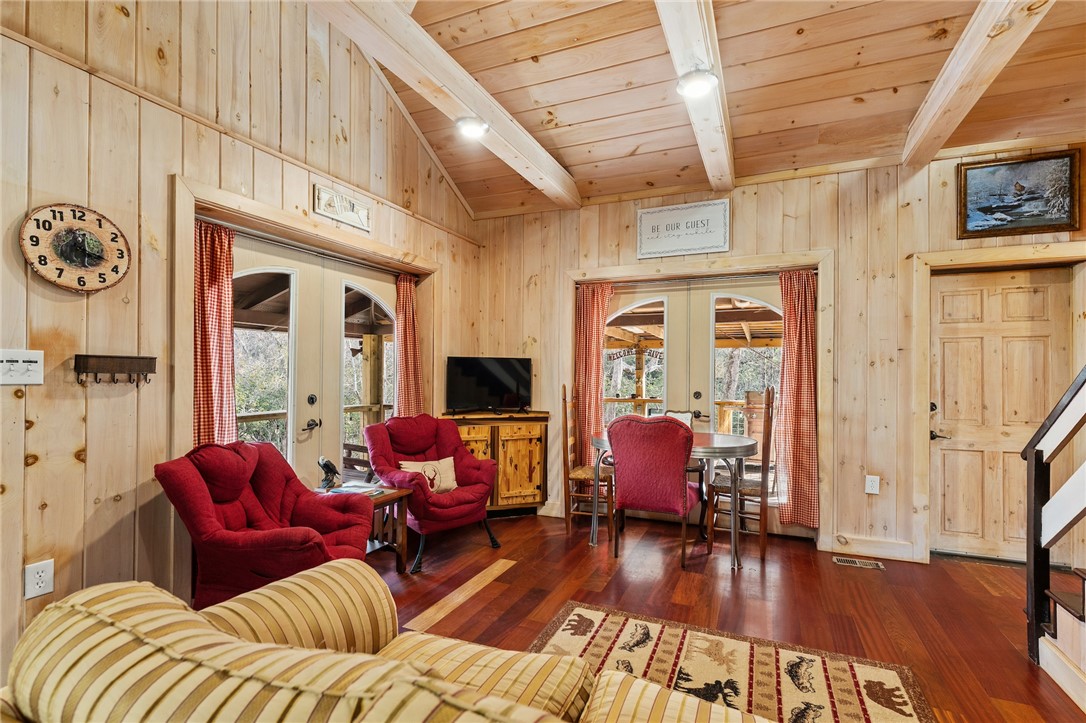 260 Hickory Ridge Mountain Rest, SC 29664 - Photo 6 of 39 This inviting living area features warm wood finishes and convenient access to an outdoor space.