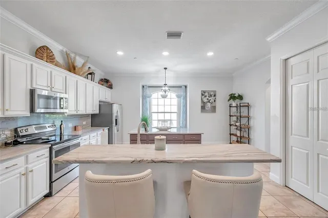 a kitchen with stainless steel appliances granite countertop a sink and cabinets