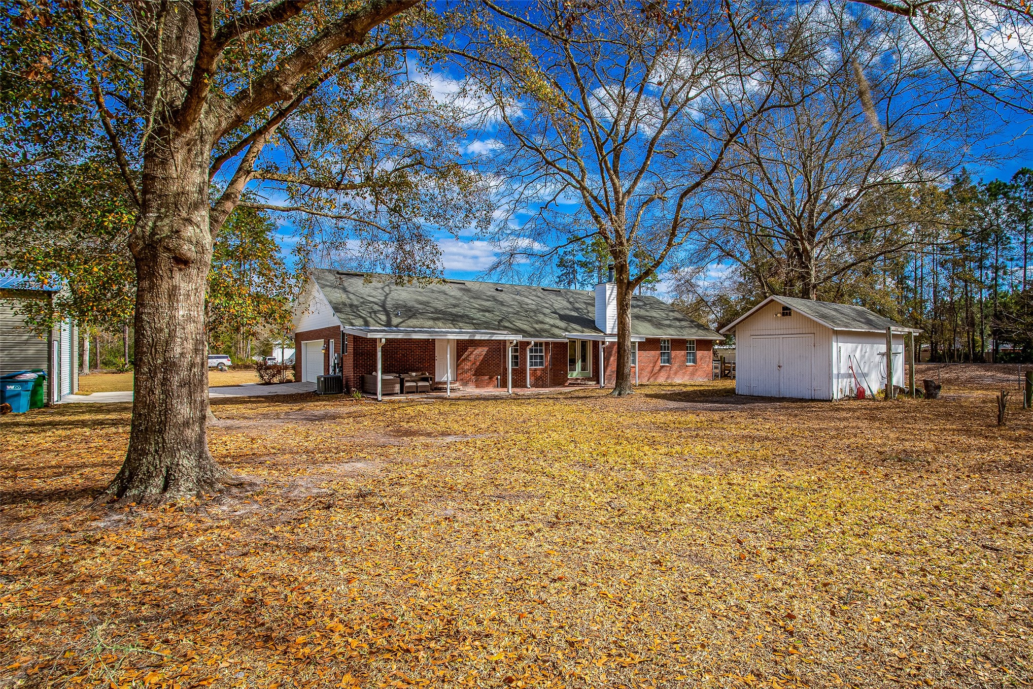 17098 Cross Branch Road Hilliard, FL 32046 - Photo 36 of 71 a view of a house with a yard covered with trees