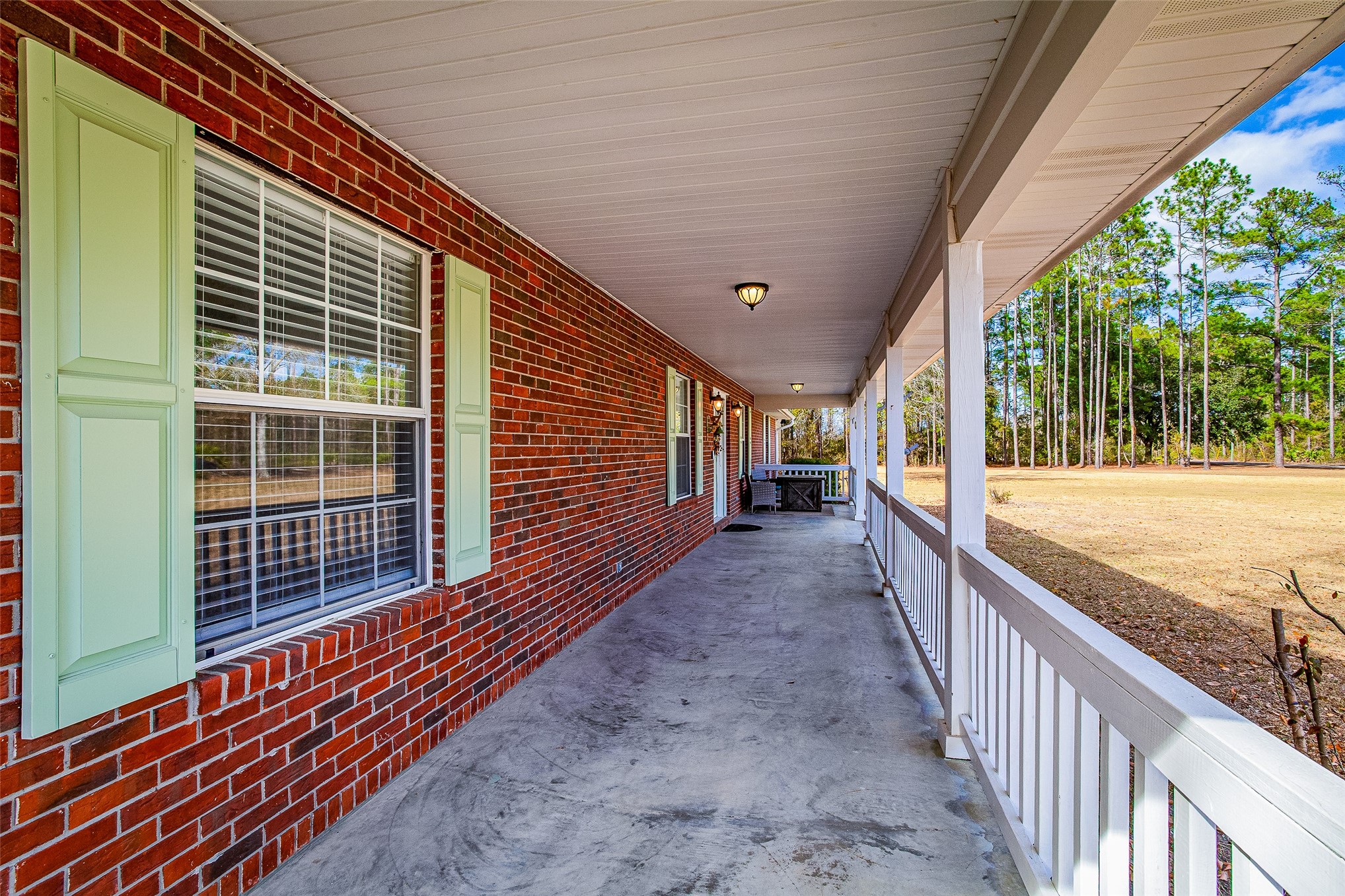 17098 Cross Branch Road Hilliard, FL 32046 - Photo 9 of 71 a view of balcony with floor to ceiling windows and wooden fence