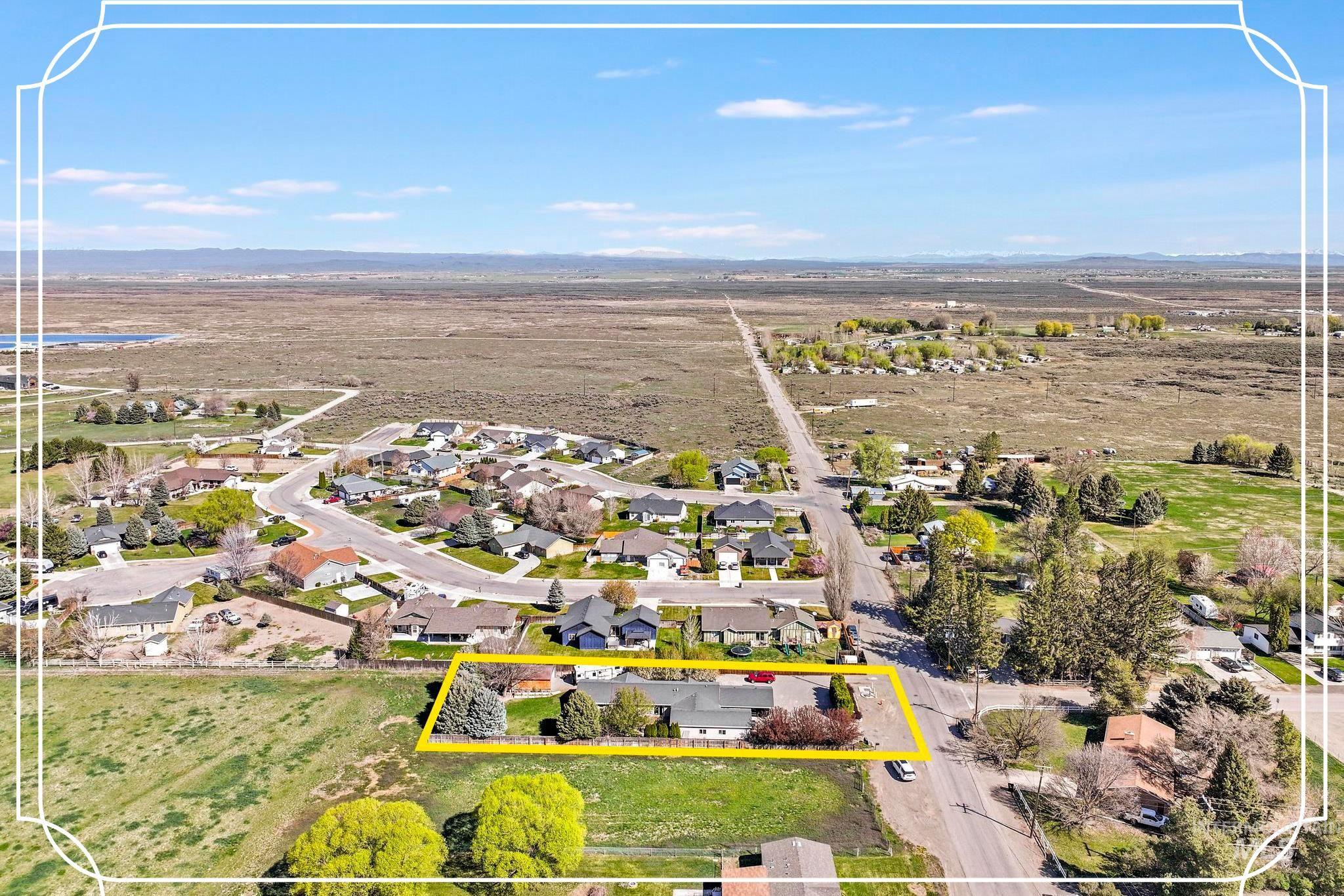 309 North Grape Street Shoshone, ID 83352 - Photo 1 of 26 Aerial view of residential area featuring property parcel outlined and mountains