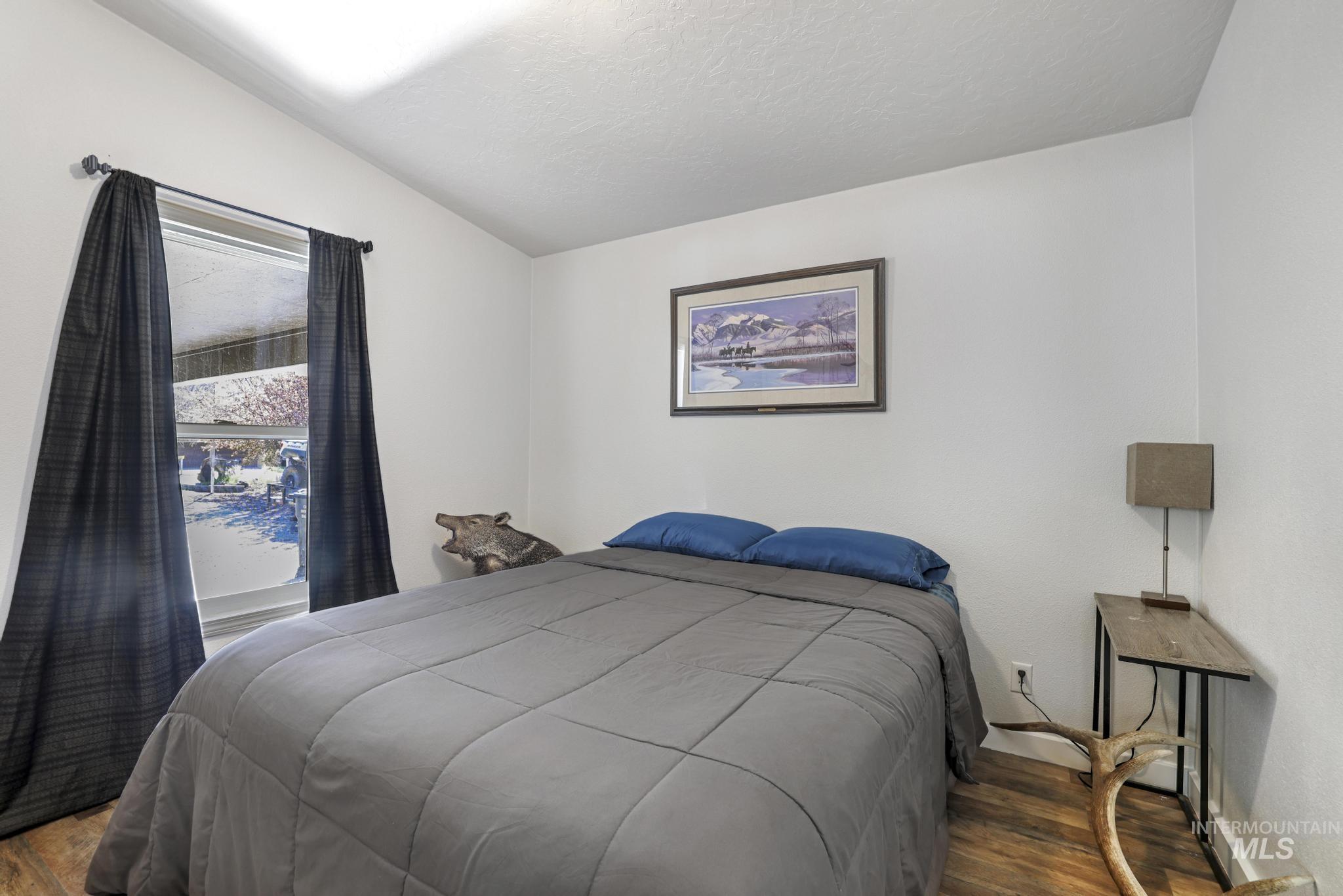 309 North Grape Street Shoshone, ID 83352 - Photo 11 of 26 Bedroom with wood finished floors and lofted ceiling