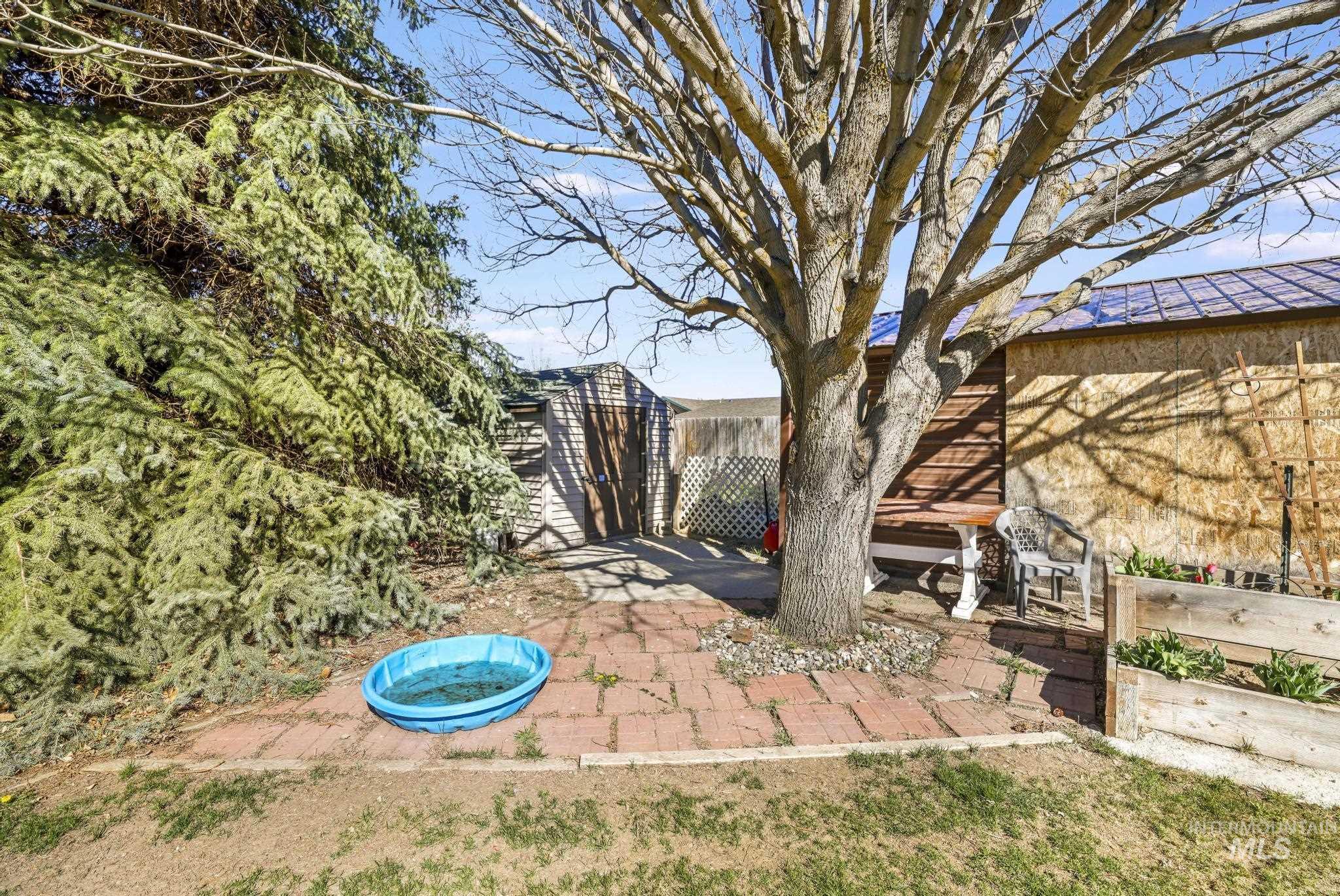 309 North Grape Street Shoshone, ID 83352 - Photo 19 of 26 View of yard featuring a storage unit and a patio area