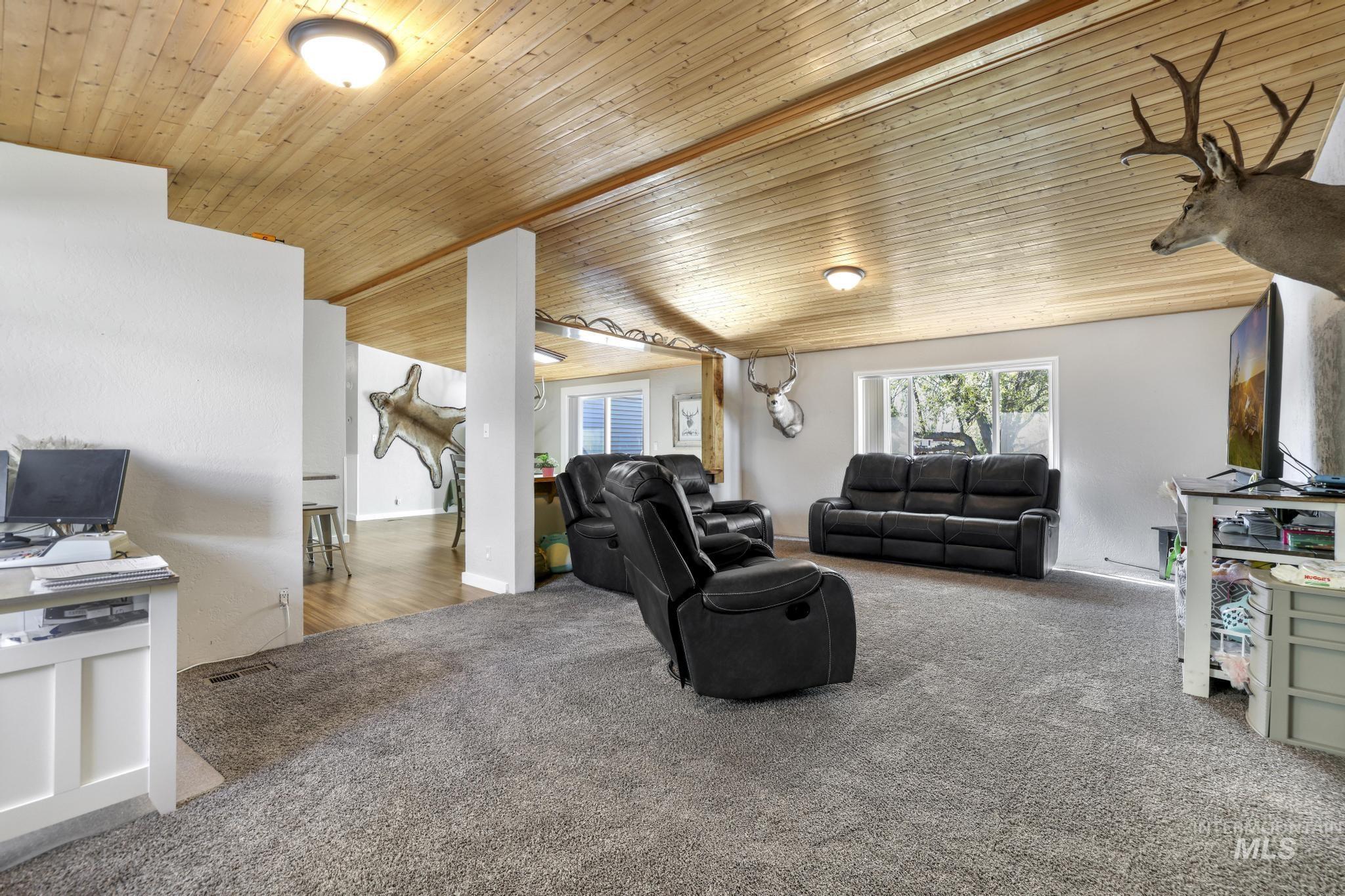 309 North Grape Street Shoshone, ID 83352 - Photo 2 of 26 Carpeted living room featuring wooden ceiling
