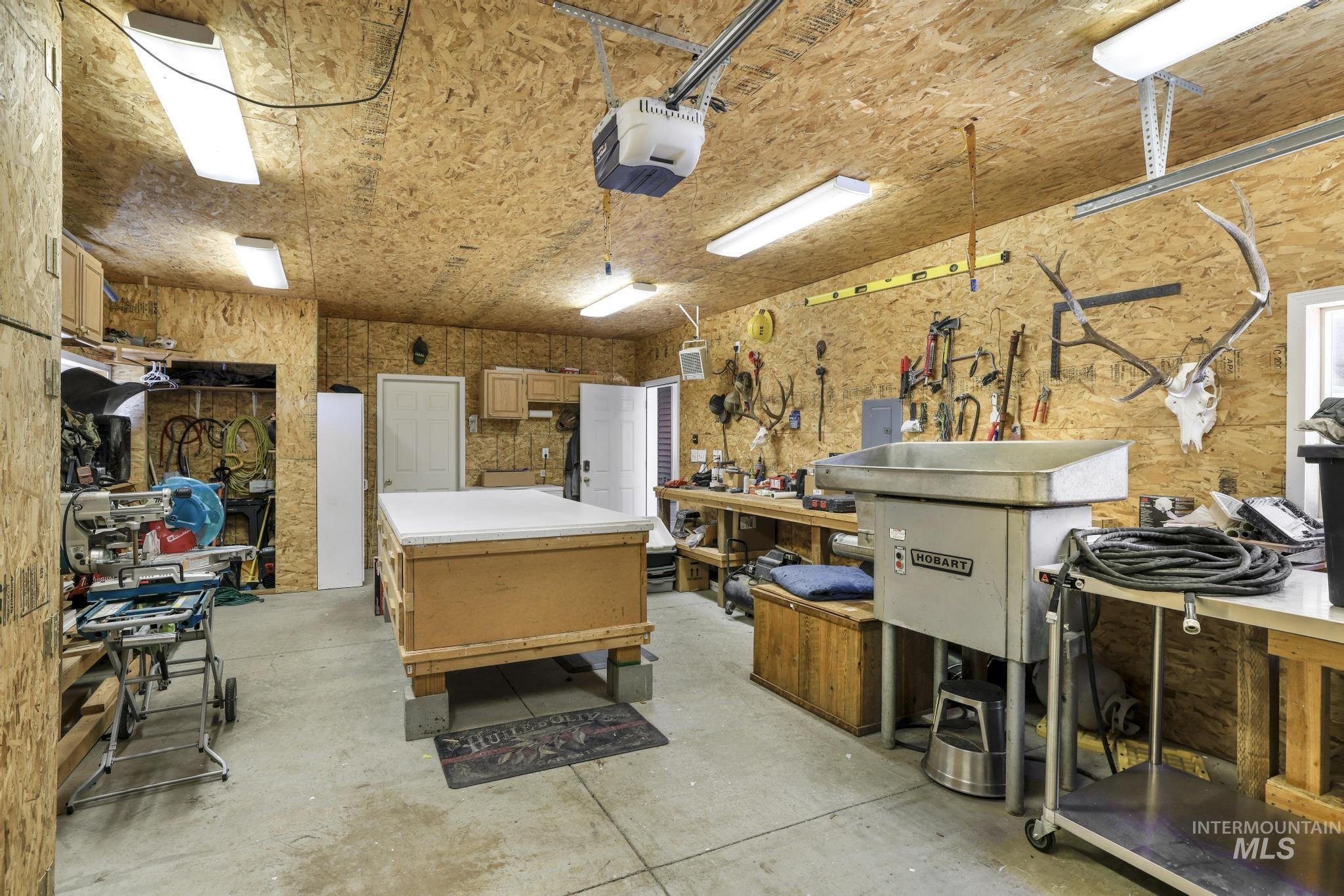 309 North Grape Street Shoshone, ID 83352 - Photo 23 of 26 Misc room with a workshop area, unfinished concrete flooring, a garage, and electric panel