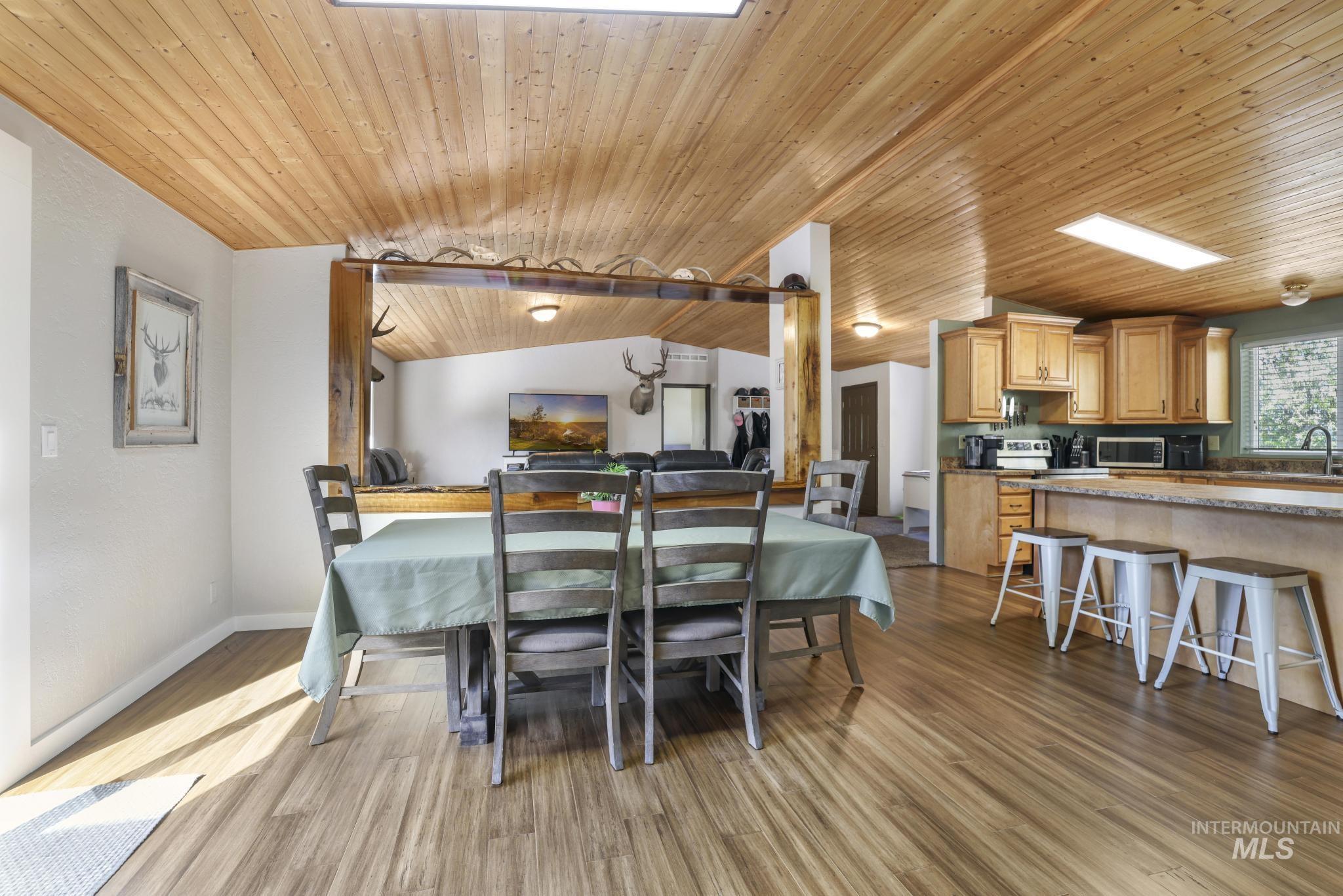 309 North Grape Street Shoshone, ID 83352 - Photo 4 of 26 Dining room with a vaulted wooden ceiling and light wood-style flooring