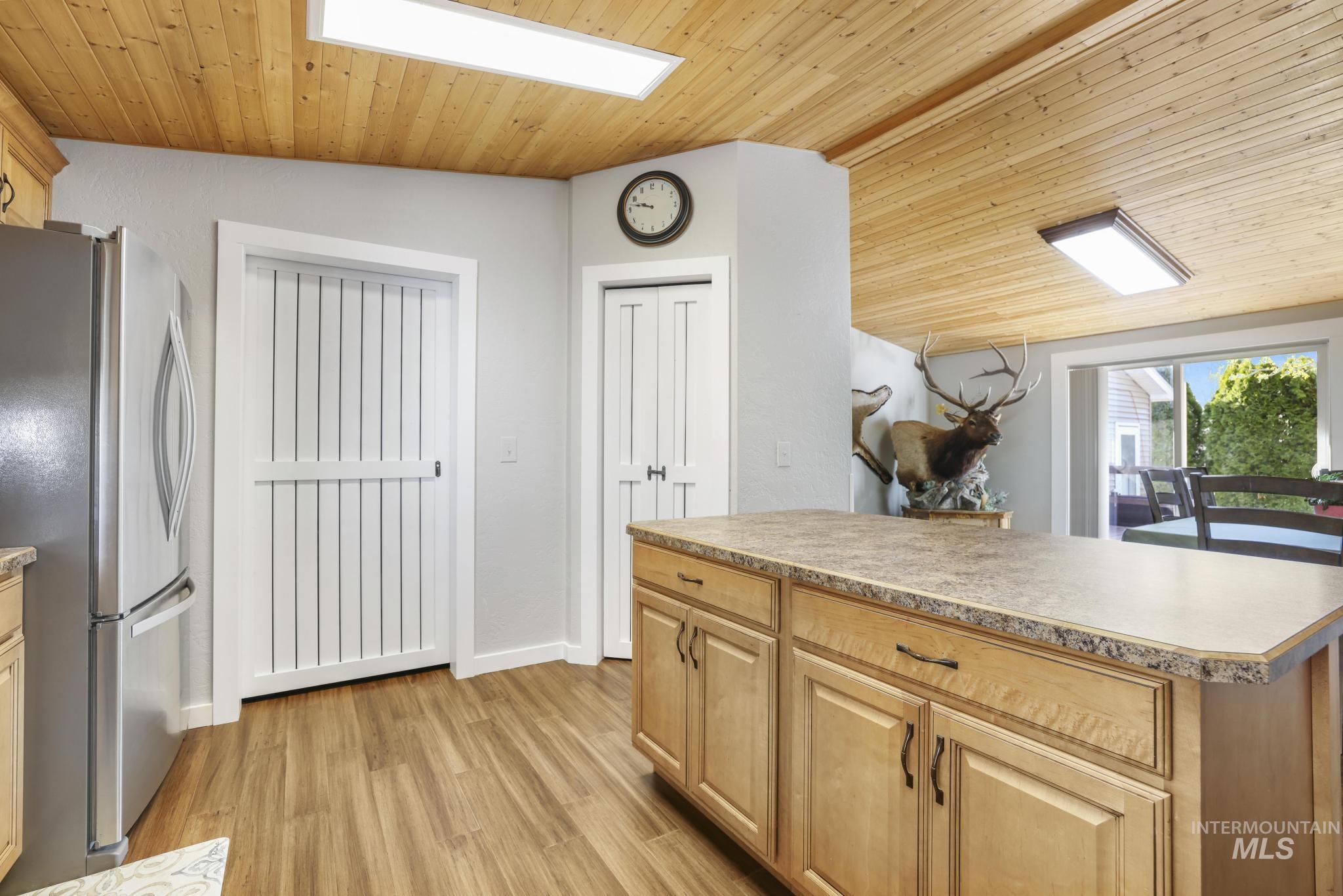 309 North Grape Street Shoshone, ID 83352 - Photo 9 of 26 Kitchen with freestanding refrigerator, a vaulted wood ceiling, light wood finished floors, light countertops, and light wood finish cabinets