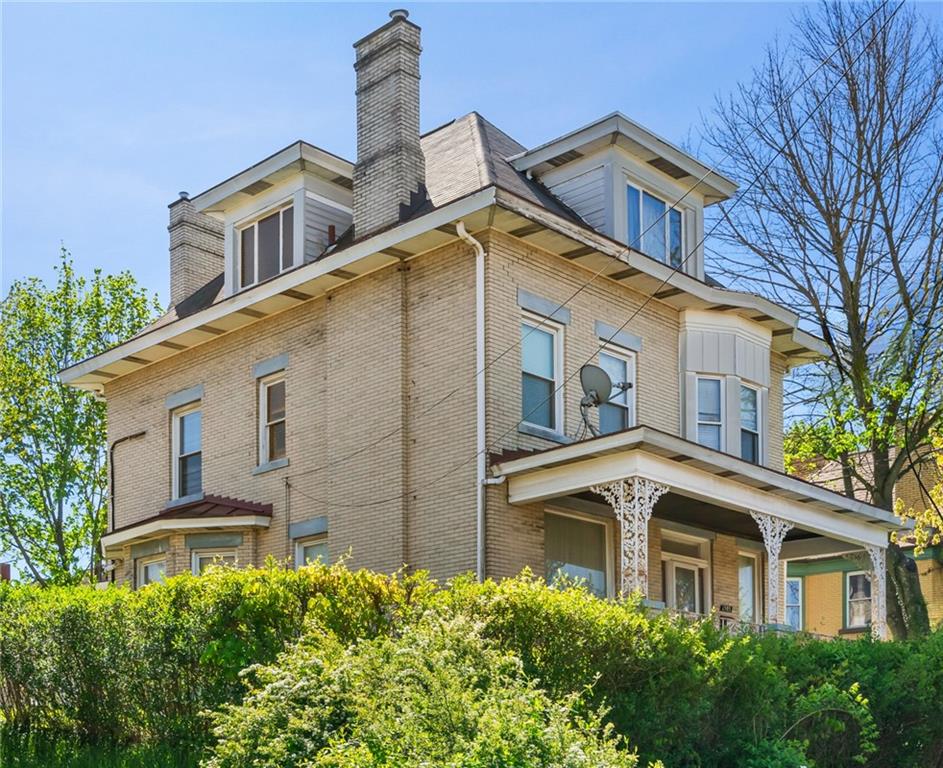 a front view of a house with a garden