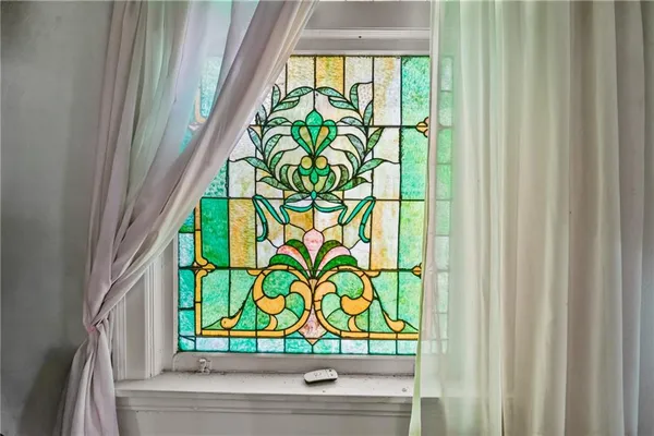 a view of a workspace with furniture and a window