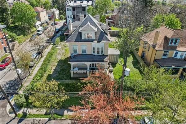 an aerial view of a house with a yard