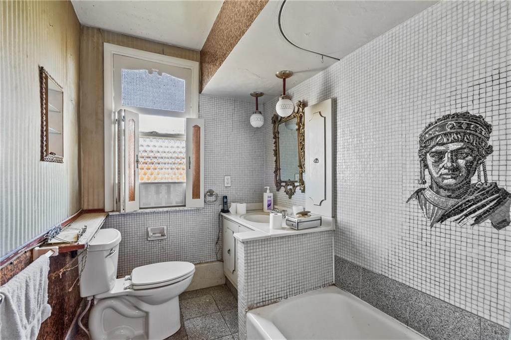 1503 Beechview Avenue Pittsburgh, PA 15216 - Photo 21 of 26 a bathroom with a toilet a sink and mirror