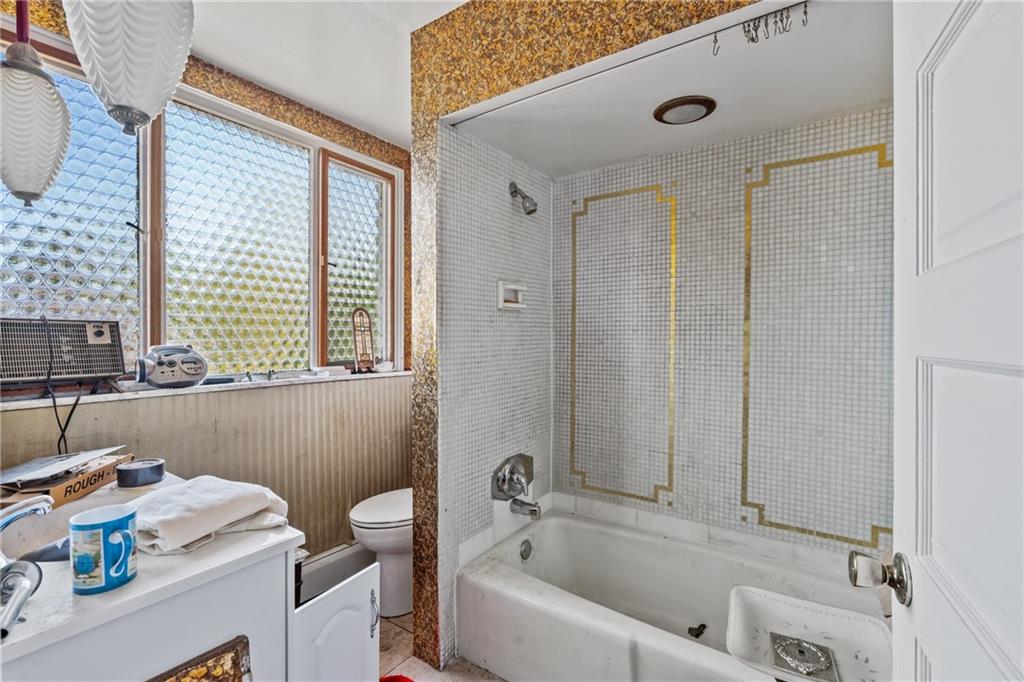 1503 Beechview Avenue Pittsburgh, PA 15216 - Photo 24 of 27 a bathroom with a tub a sink and a window