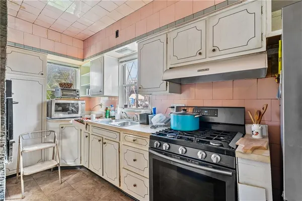 a kitchen with stainless steel appliances granite countertop a sink stove and cabinets