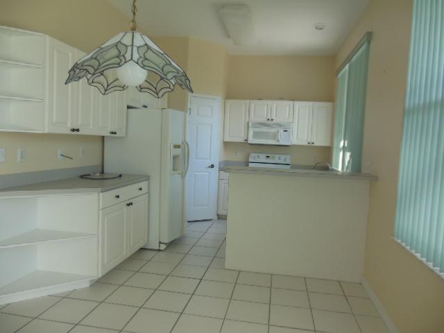865 George Street Sebastian, FL 32958 - Photo 2 of 10 a kitchen with a cabinets and chandelier