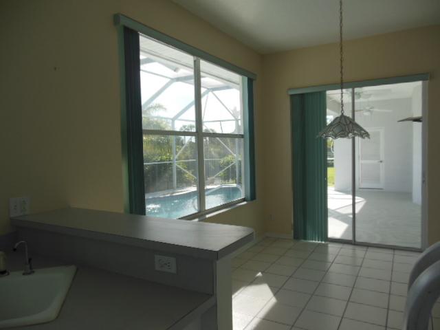 865 George Street Sebastian, FL 32958 - Photo 5 of 10 a room with a large window and chandelier
