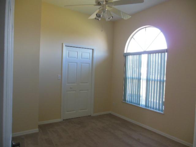 865 George Street Sebastian, FL 32958 - Photo 8 of 10 an empty room with windows and chandelier fan