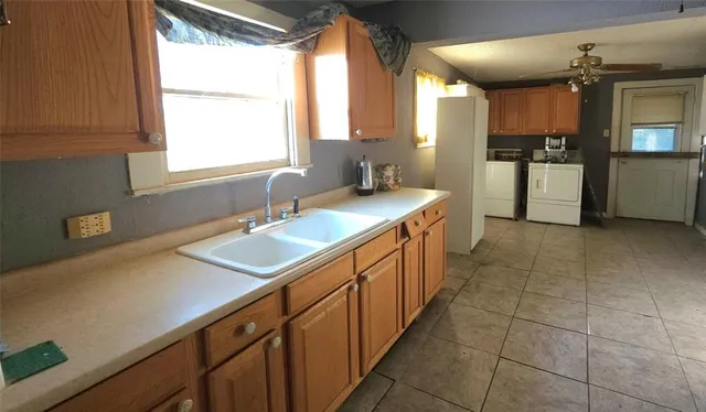 a kitchen with a sink and a refrigerator