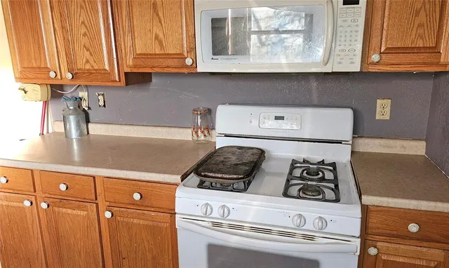 a kitchen with stainless steel appliances granite countertop a sink and a stove