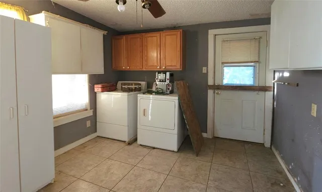 a kitchen with a stove a refrigerator and cabinets