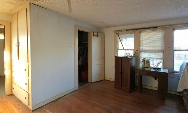 a view of workspace with wooden floor and windows
