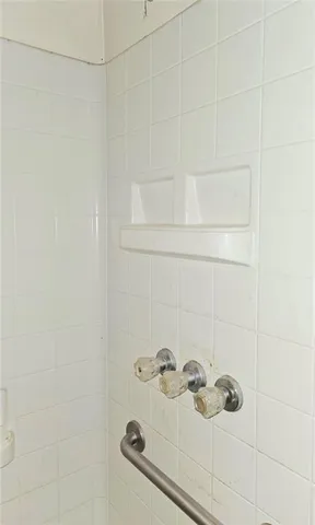 an empty room with windows and cabinet