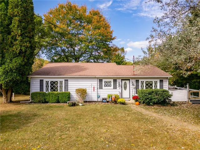 a front view of house with yard and green space