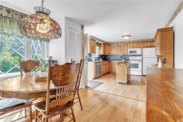 a dining room filled counter top space a kitchen view and a chair