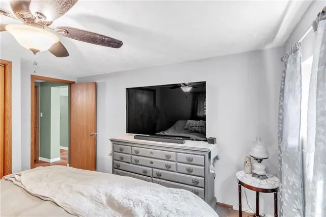 a bedroom with a bed and flat screen tv