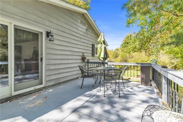 a patio with table and chairs and potted plants