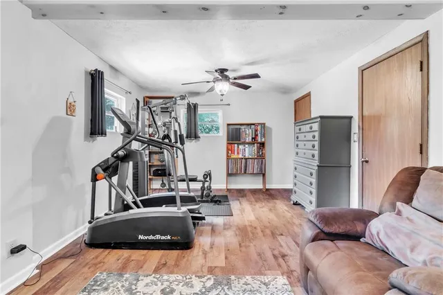 a living room with furniture a air conditioner and a window