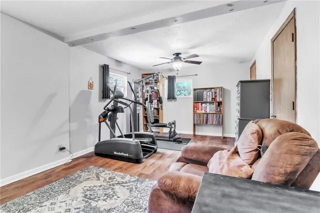 a living room with furniture gym equipment and a chandelier