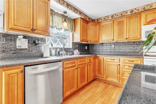 a kitchen with stainless steel appliances granite countertop a sink and a cabinets