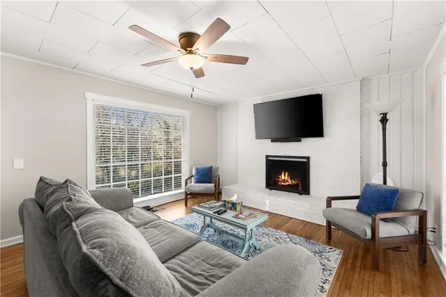 a living room with furniture a fireplace and a flat screen tv