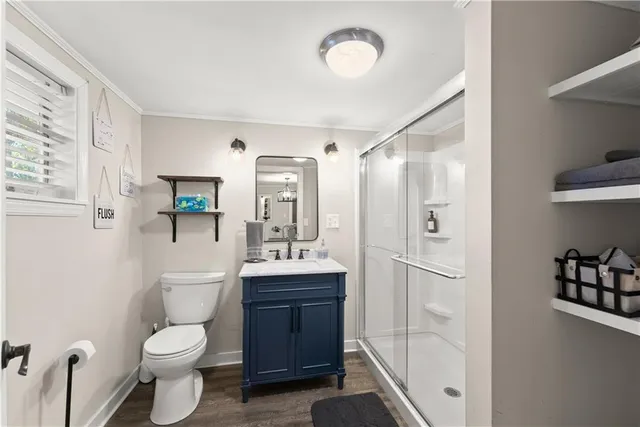 a bathroom with a toilet sink shower and mirror