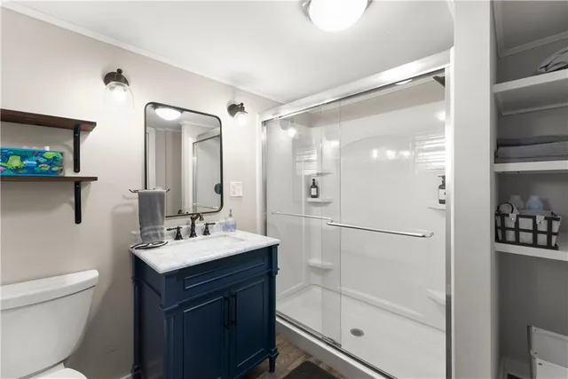 a bathroom with a sink a toilet and shower