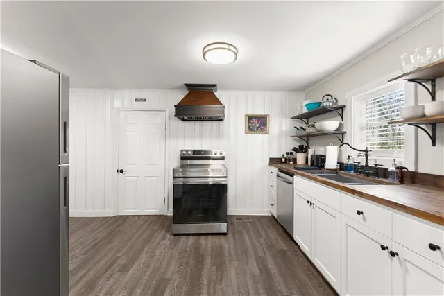 a kitchen with stainless steel appliances a sink stove and refrigerator