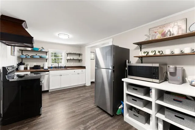 a kitchen with stainless steel appliances a refrigerator and a stove top oven
