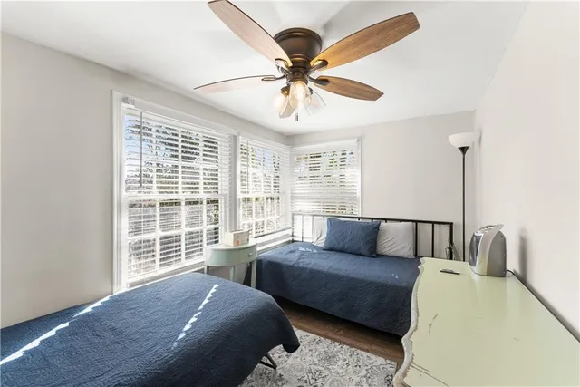 a bedroom with furniture and a large window