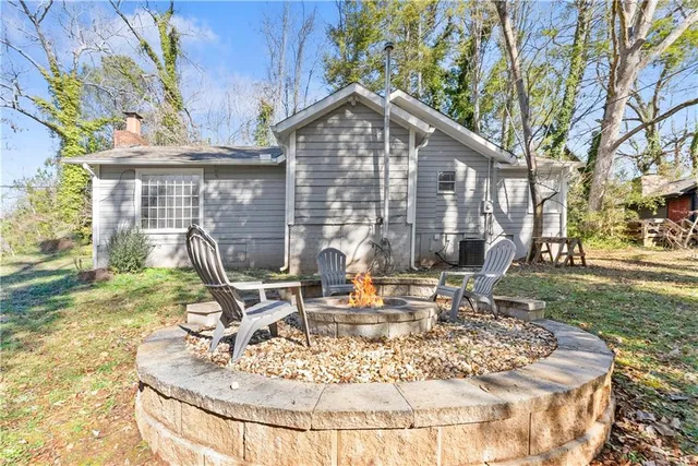 a view of a house with backyard porch and sitting area