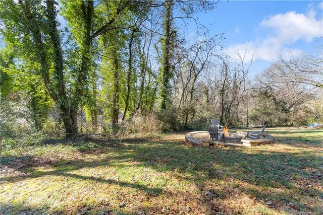 a backyard of a house with table and chairs