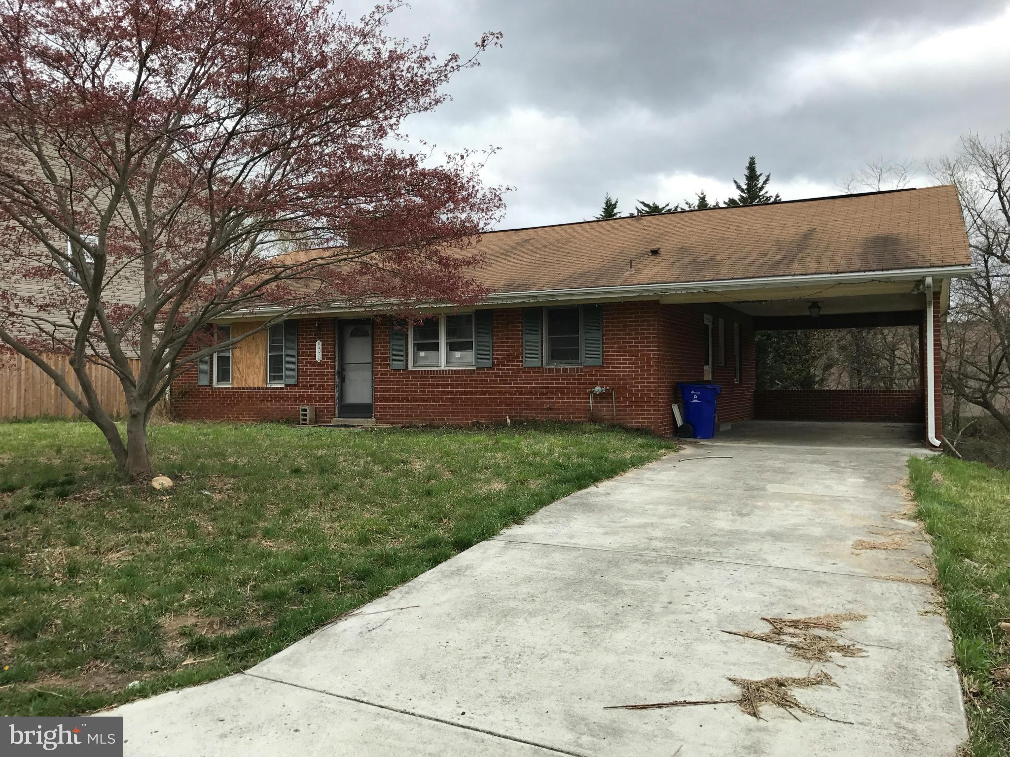 10178 High Ridge Road Laurel, MD 20723 - Photo 2 of 18 a front view of a house with a garden and trees
