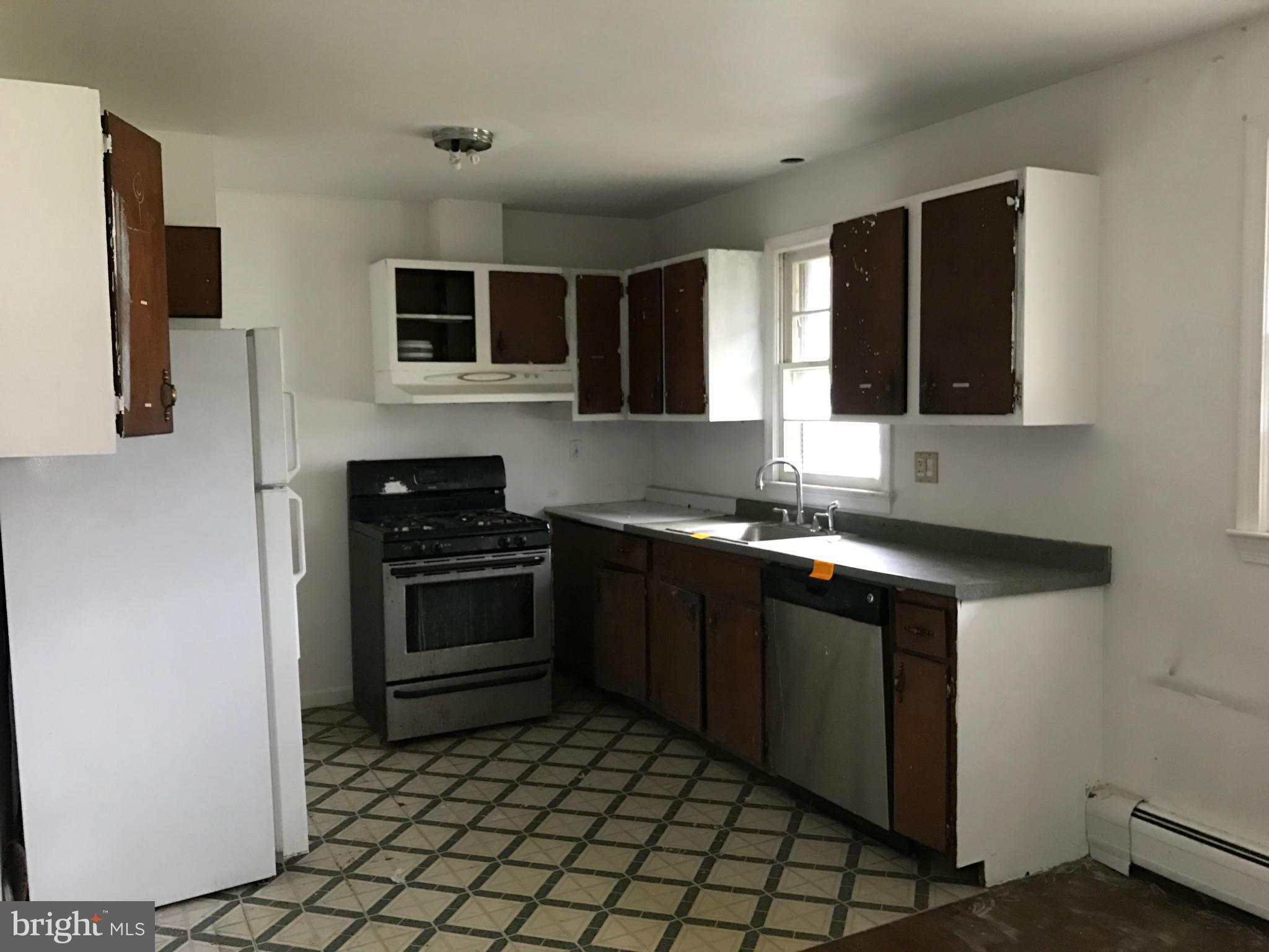 10178 High Ridge Road Laurel, MD 20723 - Photo 3 of 18 a kitchen with stainless steel appliances granite countertop a stove a sink and a microwave