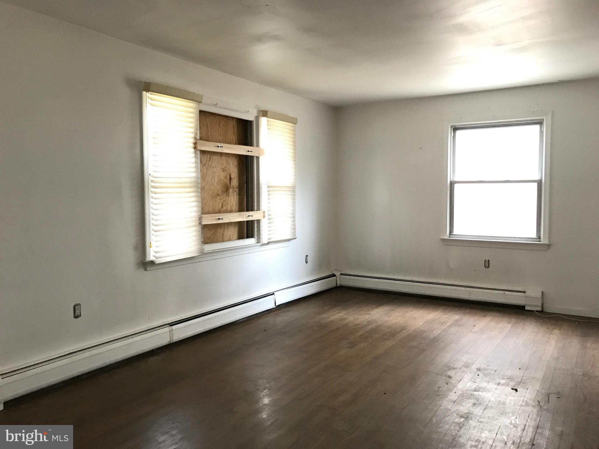 10178 High Ridge Road Laurel, MD 20723 - Photo 5 of 18 an empty room with wooden floor and windows