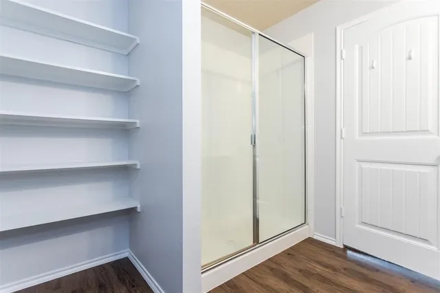 a view of walk in closet with empty racks