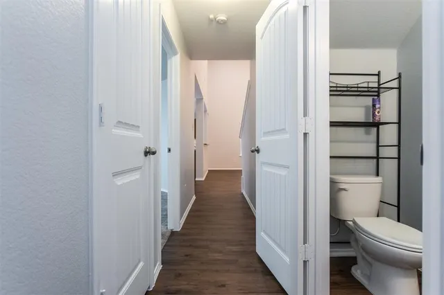 a white toilet sitting next to a shower